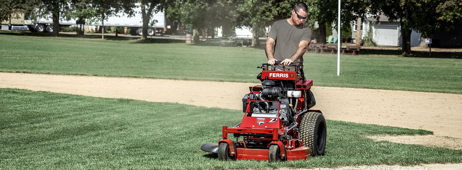 Man riding stand on commercial mower