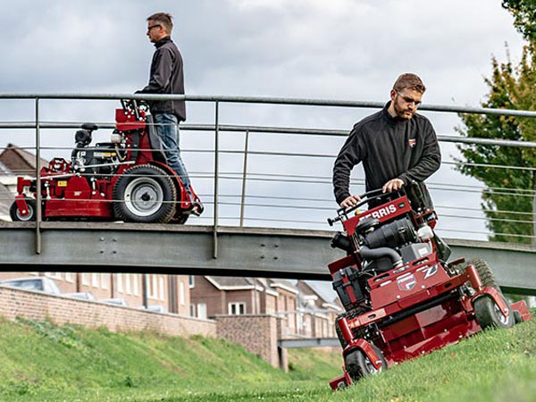 Man riding stand on commercial mower