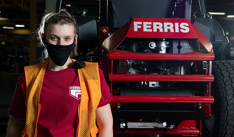 Woman standing in front of Ferris mower
